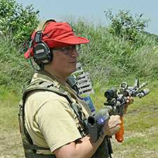 Steven Hoober in red hat demonstrating to a class how to use the AR-15 carbine.
